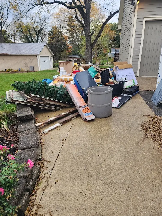 Dumpster being loaded with debris for Estate Cleanout Dumpster Rental in Moorefield